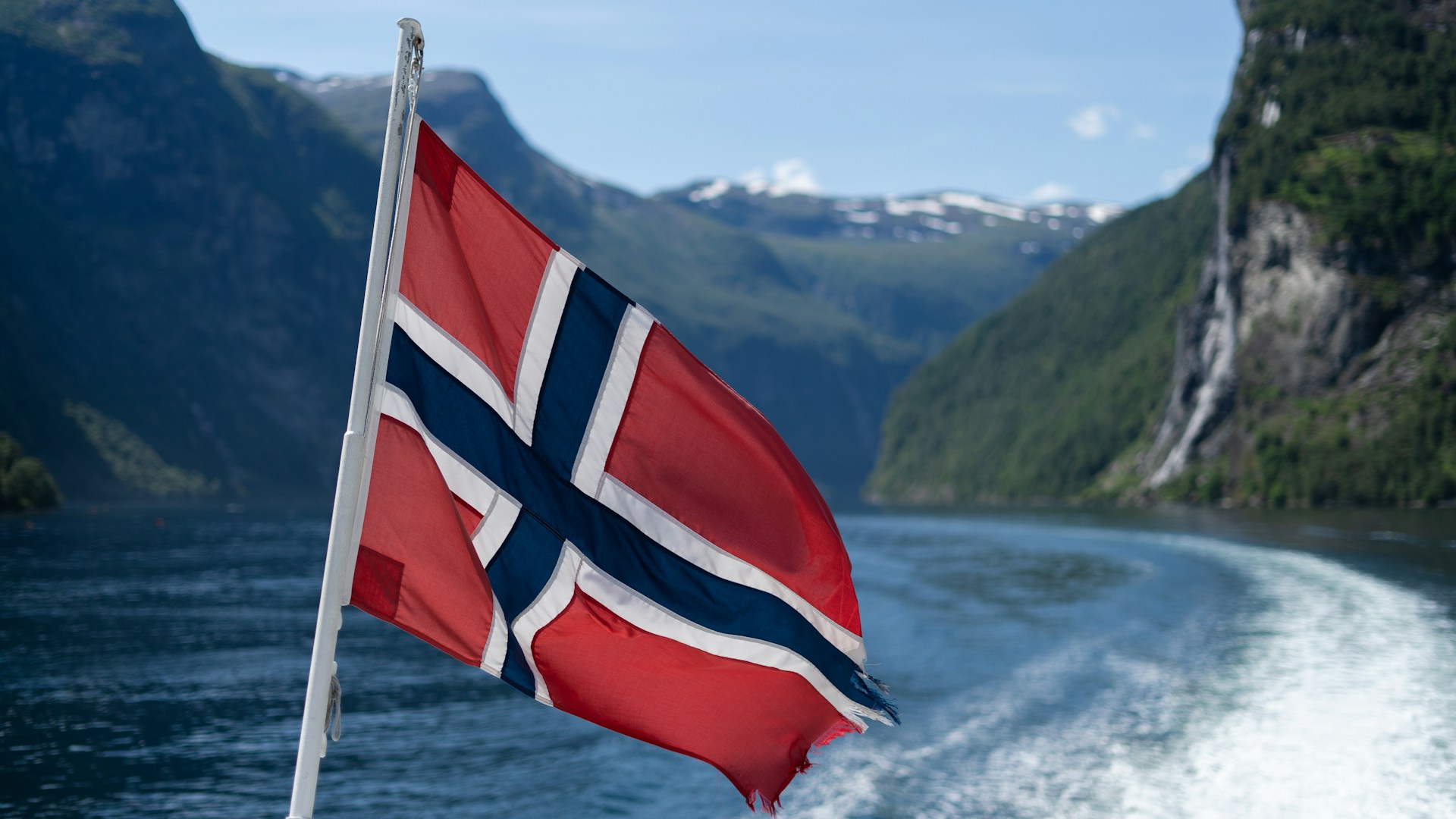 Norwegian flag flying from a boat on the water